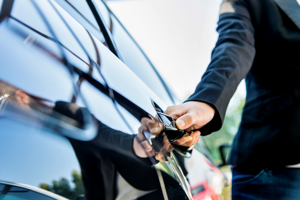 Closeup of driver's hand opening car door